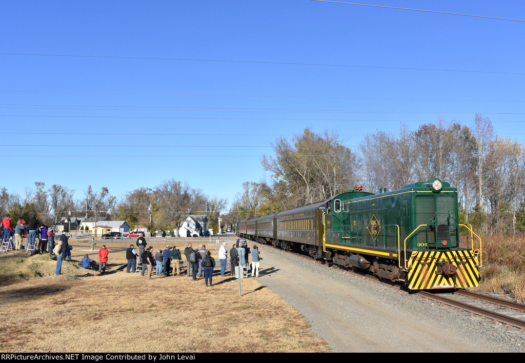 The Baldwin S-12 powers the passenger photo charter special just south of Bailey St in Woodstown. Marvin L. Watson Memorial Park is in the background on the left 